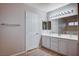 Double vanity bathroom with wood-look flooring and a linen closet at 2214 Sexton Ave, North Las Vegas, NV 89031