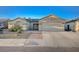 Single-story home with two car garage and landscaping at 2214 Sexton Ave, North Las Vegas, NV 89031