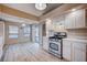 Updated kitchen with white cabinets, stainless steel appliances, and wood-look vinyl flooring at 2214 Sexton Ave, North Las Vegas, NV 89031