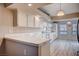 Eat-in kitchen with white cabinets, tile countertops, and wood-look flooring at 2214 Sexton Ave, North Las Vegas, NV 89031