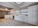 Kitchen with white cabinets, stainless steel appliances, and wood-look vinyl flooring at 2214 Sexton Ave, North Las Vegas, NV 89031