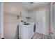 Functional laundry room with washer, dryer, and shelving at 2214 Sexton Ave, North Las Vegas, NV 89031