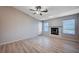 Spacious living room with wood-look floors, fireplace, and ceiling fan at 2214 Sexton Ave, North Las Vegas, NV 89031