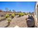 Backyard features gravel, plants, and a grill area at 2408 Sky Watcher St, Henderson, NV 89044