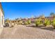 Spacious backyard with gravel and drought-tolerant plants at 2408 Sky Watcher St, Henderson, NV 89044