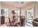 Dining area with glass table, dark chairs, and access to the backyard at 2408 Sky Watcher St, Henderson, NV 89044