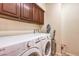 Laundry room with washer, dryer, and overhead cabinets at 2408 Sky Watcher St, Henderson, NV 89044