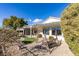 A cozy backyard with a covered patio, gravel ground cover, and a swing bench at 2429 Anderson Park Dr, Henderson, NV 89044