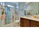 Bathroom with glass enclosed shower, single sink vanity with dark wood cabinets, and a large mirror at 2429 Anderson Park Dr, Henderson, NV 89044