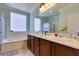 Bathroom with double sinks, soaking tub, and separate shower at 2429 Anderson Park Dr, Henderson, NV 89044