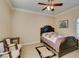 Well-lit bedroom featuring a ceiling fan, a floral wall decor, and a comfortable bed with a classic wooden frame at 2429 Anderson Park Dr, Henderson, NV 89044