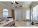 Bedroom with neutral walls, tiled floor, a ceiling fan, and a window with blinds, offering a bright and airy ambiance at 2429 Anderson Park Dr, Henderson, NV 89044