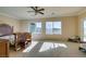 Main bedroom with large windows and ceiling fan at 2429 Anderson Park Dr, Henderson, NV 89044