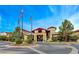 Beautiful clubhouse entrance with American and Nevada state flags flying on a bright day at 2429 Anderson Park Dr, Henderson, NV 89044