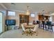 Cozy dining area featuring a chandelier, kitchen bar and adjacent TV area at 2429 Anderson Park Dr, Henderson, NV 89044