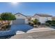 Single-story house featuring a gray garage door and well-maintained landscaping at 2429 Anderson Park Dr, Henderson, NV 89044