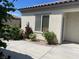 Exterior shot of single-story home with blooming rose bushes along the window at 2429 Anderson Park Dr, Henderson, NV 89044