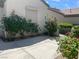 Home exterior with desert landscaping, featuring rocks, concrete, roses and other plants at 2429 Anderson Park Dr, Henderson, NV 89044