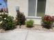 Exterior shot of single-story home with rose bushes and an American flag at 2429 Anderson Park Dr, Henderson, NV 89044