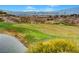 Picturesque golf course view showcasing the green with a pond and Las Vegas skyline in the distance at 2429 Anderson Park Dr, Henderson, NV 89044