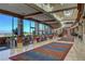 Long hallway featuring floor to ceiling windows, bright lighting, tile floors and area rugs at 2429 Anderson Park Dr, Henderson, NV 89044