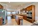 Spacious kitchen featuring an island, tile flooring, stainless steel appliances, and custom wood cabinetry at 2429 Anderson Park Dr, Henderson, NV 89044