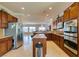 Modern kitchen with stainless steel appliances, granite countertops, island, and seamless flow to the living area at 2429 Anderson Park Dr, Henderson, NV 89044