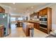 Updated kitchen with granite countertops, stainless appliances, breakfast bar and seamless open layout to the living area at 2429 Anderson Park Dr, Henderson, NV 89044