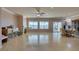 Spacious living room with tile flooring, fireplace, ceiling fan, and large windows at 2429 Anderson Park Dr, Henderson, NV 89044