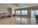 Spacious living room with tile flooring, fireplace, ceiling fan, and natural light at 2429 Anderson Park Dr, Henderson, NV 89044