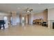 Open layout living area with tile flooring, seamlessly connecting to the kitchen and dining areas at 2429 Anderson Park Dr, Henderson, NV 89044