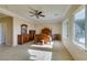 Spacious main bedroom with carpet, a ceiling fan, a large window, and a full bedroom set at 2429 Anderson Park Dr, Henderson, NV 89044