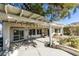 Covered back patio featuring a pergola roof and seating areas with mature landscaping at 2429 Anderson Park Dr, Henderson, NV 89044