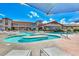 Relaxing outdoor pool area with ample seating and a view of the building at 2429 Anderson Park Dr, Henderson, NV 89044