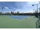 Two well-lit tennis courts with green surface at 2429 Anderson Park Dr, Henderson, NV 89044