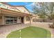 Home features a backyard with putting green and covered patio at 2571 Hazelburn Ave, Henderson, NV 89044