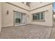 Small paved patio with sliding glass doors and exterior lights at 2571 Hazelburn Ave, Henderson, NV 89044