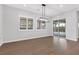 Bright dining room with hardwood floors, chandelier, and sliding glass doors at 2571 Hazelburn Ave, Henderson, NV 89044