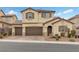 Two-story house with brown doors and shutters, a paved driveway, and landscaping at 2571 Hazelburn Ave, Henderson, NV 89044