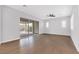 Living room with hardwood floors and sliding glass doors leading to the patio at 2571 Hazelburn Ave, Henderson, NV 89044