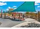 Modern playground with musical instrument play features and shade structure at 2571 Hazelburn Ave, Henderson, NV 89044