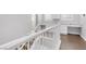 Upstairs hallway with white railings and built in cabinetry at 2571 Hazelburn Ave, Henderson, NV 89044