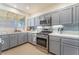 Well-equipped kitchen featuring gray cabinets and stainless steel appliances at 2789 Trotwood Ln, Las Vegas, NV 89108