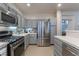 Modern kitchen with stainless steel appliances and gray cabinets at 2789 Trotwood Ln, Las Vegas, NV 89108