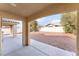 Covered patio and spacious backyard with gravel at 3008 Blush Noisette Ave, North Las Vegas, NV 89081