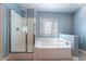 Clean bathroom with a large shower and soaking tub at 3008 Blush Noisette Ave, North Las Vegas, NV 89081