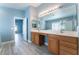 Double vanity bathroom with wood cabinets and separate shower and tub at 3008 Blush Noisette Ave, North Las Vegas, NV 89081