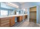 Double vanity bathroom with wood cabinets and large mirror at 3008 Blush Noisette Ave, North Las Vegas, NV 89081