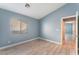 Bright bedroom with light blue walls and wood-look flooring at 3008 Blush Noisette Ave, North Las Vegas, NV 89081