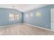 Spacious bedroom with light blue walls and wood-look flooring at 3008 Blush Noisette Ave, North Las Vegas, NV 89081